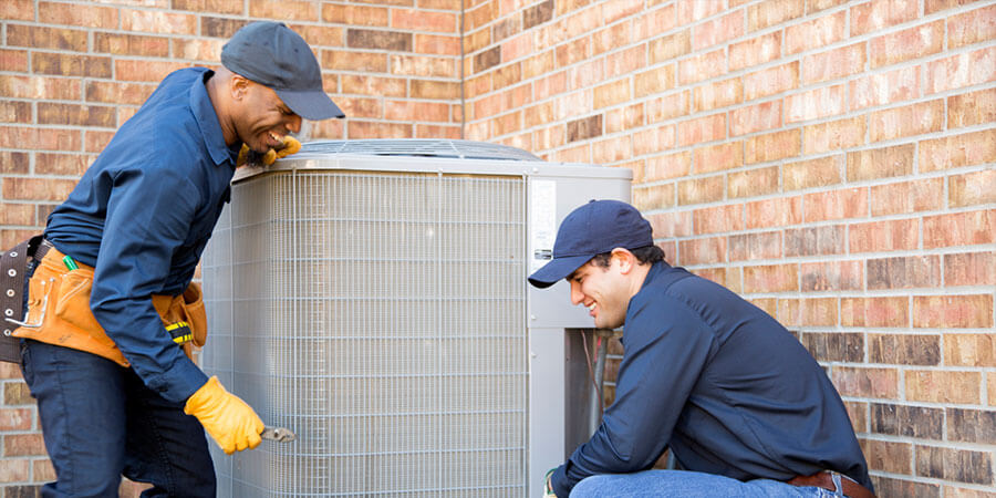 Service technicians installing an air conditioner
